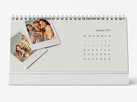 A desk calendar template with Polaroid photos in a minimalist retro style.