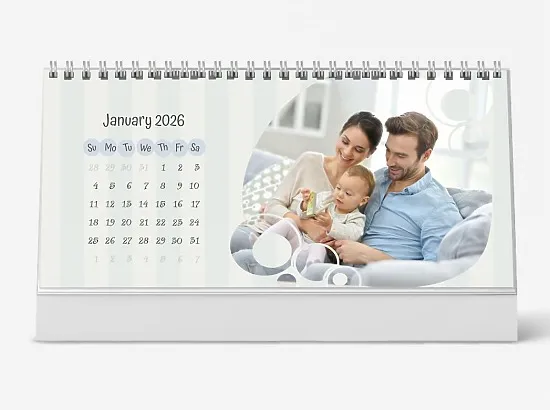 A delicate desk calendar template featuring a happy young family with a small child in their own home, in pastel tones.